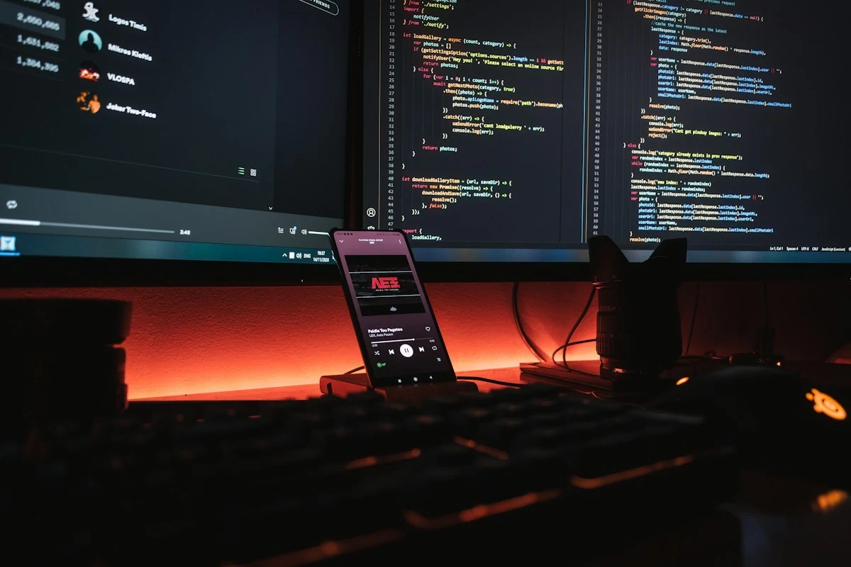 Developer dual monitor workstation comparing voice AI SDKs